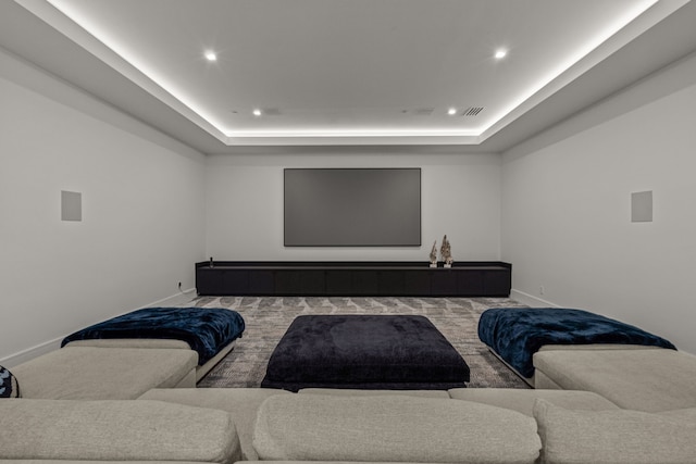 home theater room with a tray ceiling