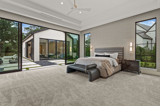 bedroom featuring ceiling fan, a high ceiling, access to outside, and carpet floors