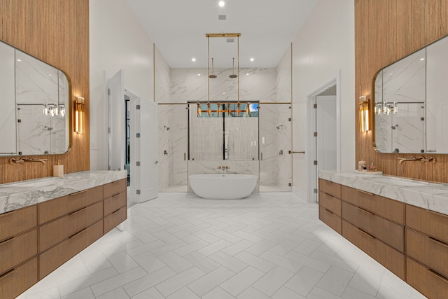 bathroom with vanity, a towering ceiling, and shower with separate bathtub