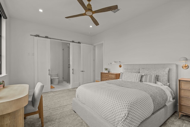 bedroom with ceiling fan and connected bathroom