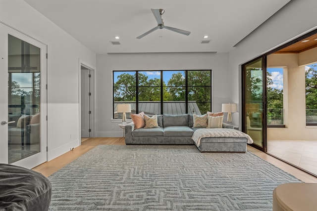 sunroom / solarium featuring ceiling fan