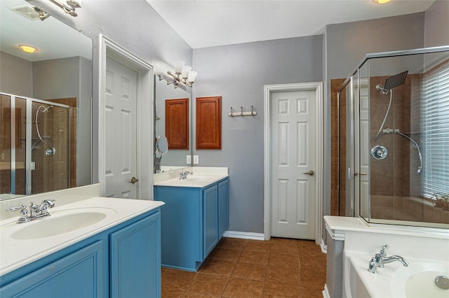 bathroom featuring a shower with door, vanity, and tile patterned flooring