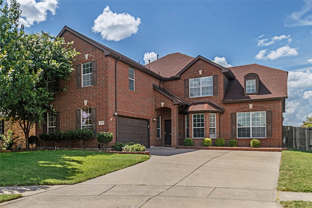 view of front facade with a front yard and a garage