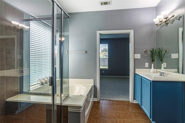bathroom with tile patterned flooring, vanity, and separate shower and tub
