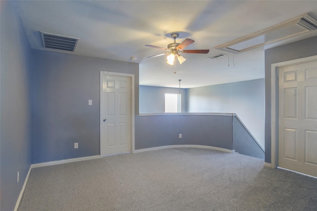 carpeted spare room featuring ceiling fan