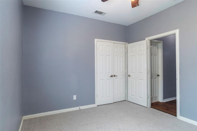 unfurnished bedroom featuring carpet floors, ceiling fan, and a closet