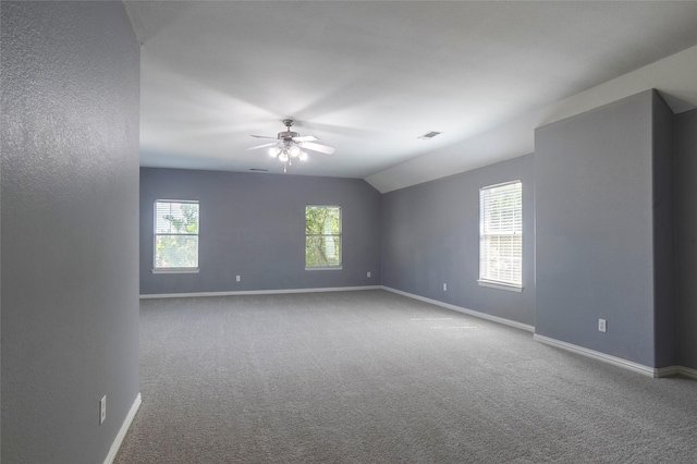 carpeted empty room with ceiling fan and lofted ceiling