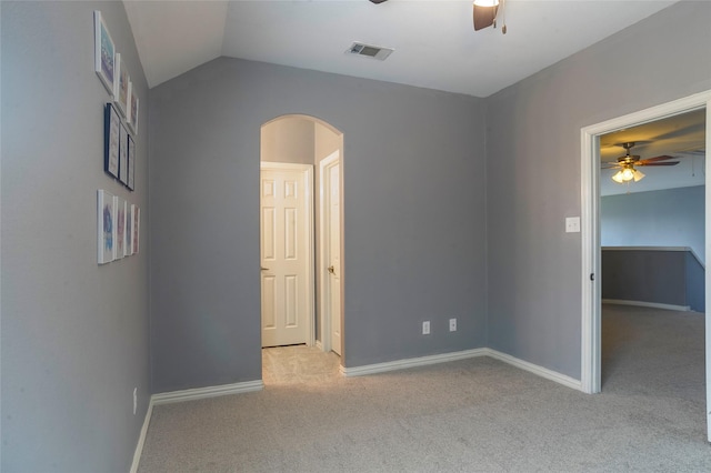 unfurnished bedroom with light carpet, ceiling fan, and lofted ceiling