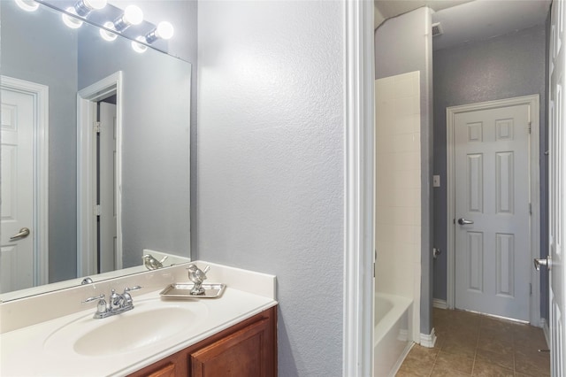 bathroom featuring tile patterned flooring and vanity