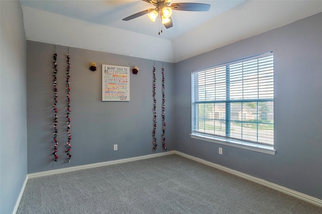 carpeted empty room with ceiling fan and vaulted ceiling