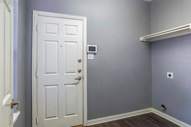clothes washing area featuring electric dryer hookup and dark hardwood / wood-style flooring
