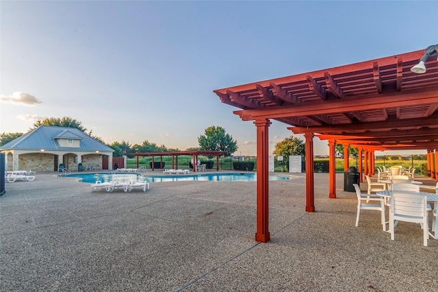 view of pool featuring a patio, an outdoor structure, and a pergola