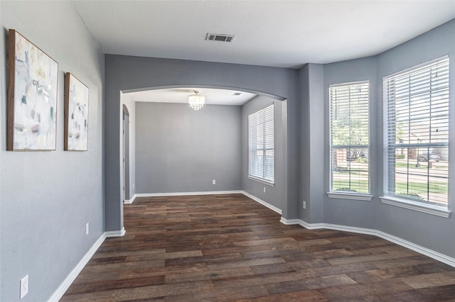 spare room with dark hardwood / wood-style flooring