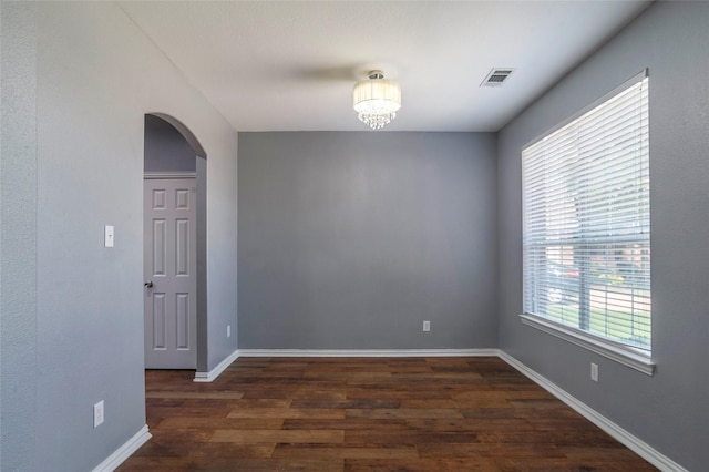 unfurnished room with dark hardwood / wood-style flooring