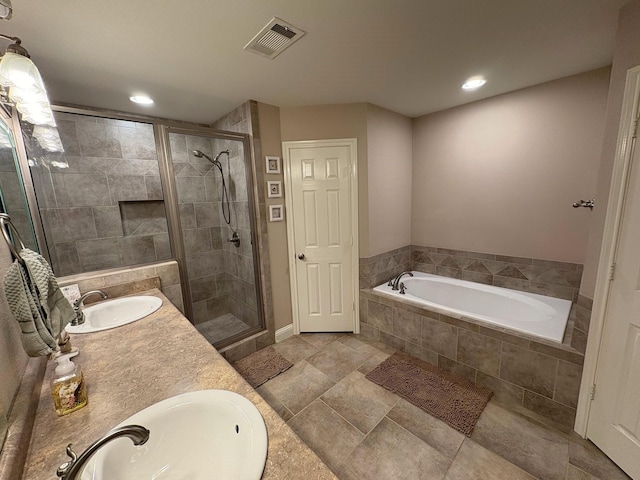 bathroom featuring shower with separate bathtub and vanity