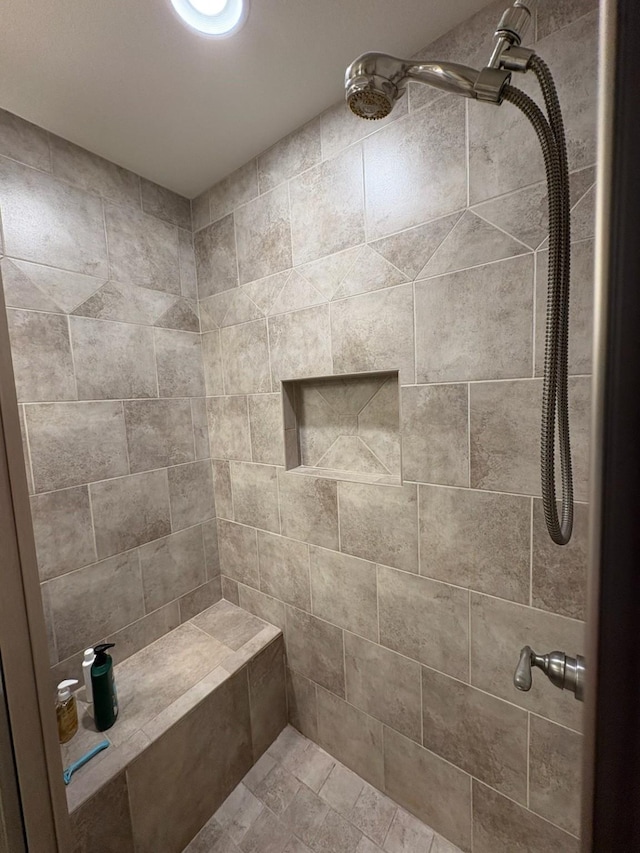 bathroom with a tile shower