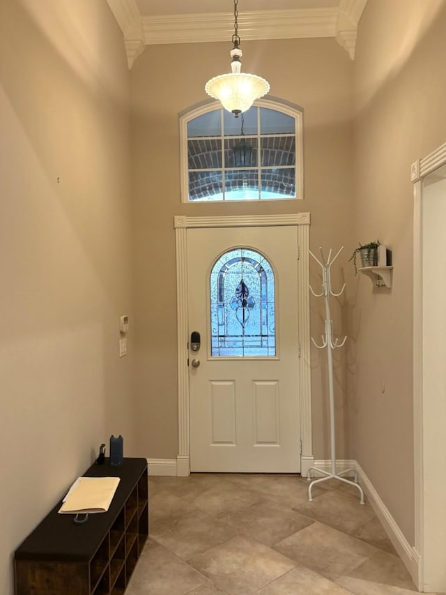 entrance foyer with a high ceiling and crown molding