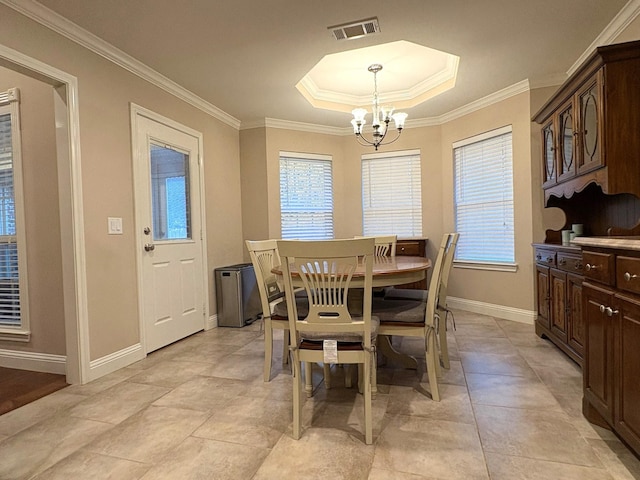 tiled dining room featuring a notable chandelier, a tray ceiling, and ornamental molding