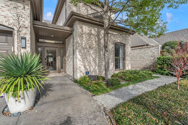 property entrance featuring brick siding