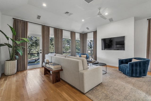 living room featuring light wood-type flooring and ceiling fan