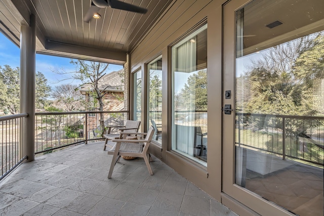 sunroom / solarium with wooden ceiling and ceiling fan