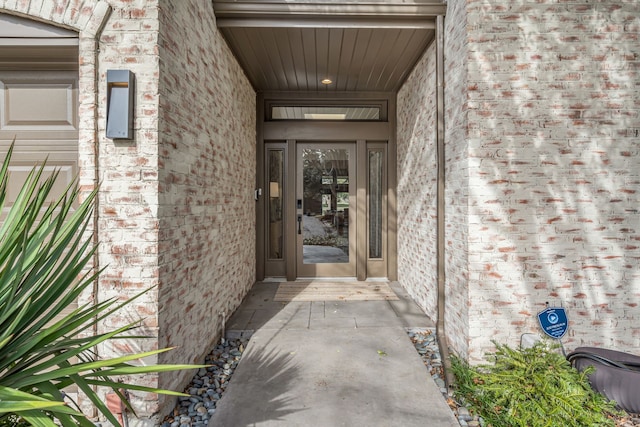 entrance to property with brick siding