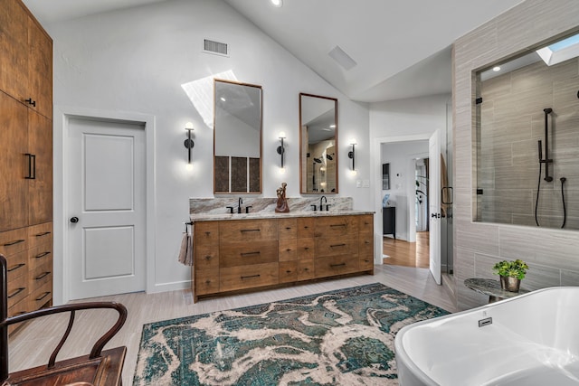 bathroom featuring high vaulted ceiling, vanity, shower with separate bathtub, and hardwood / wood-style flooring