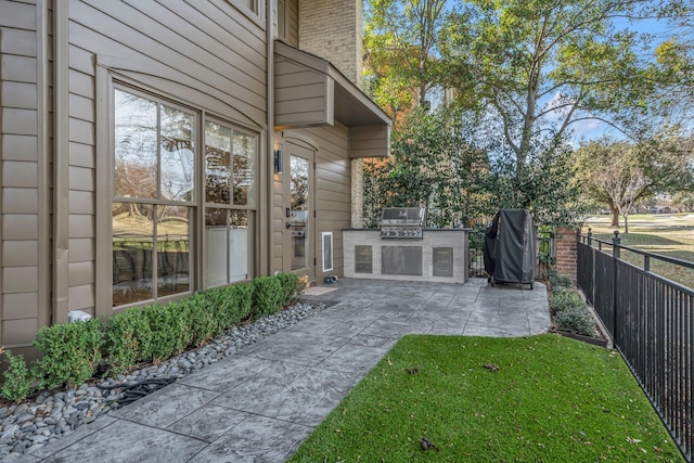 exterior space featuring exterior kitchen, a patio, and fence