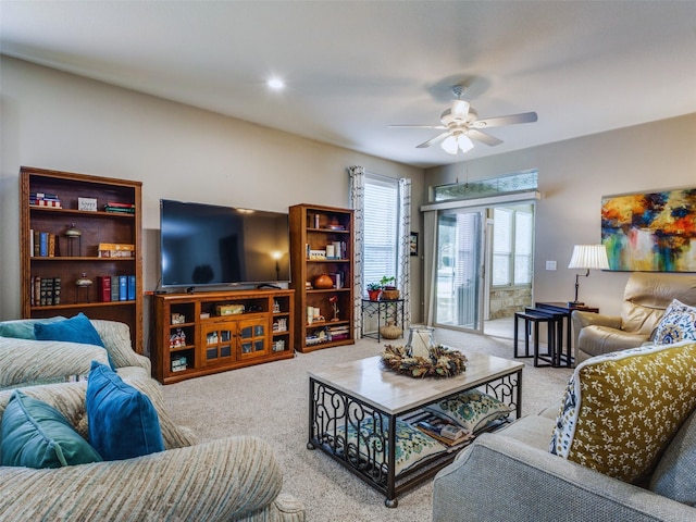 carpeted living room featuring ceiling fan