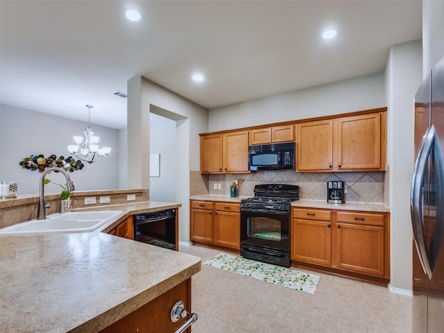 kitchen with a notable chandelier, black appliances, sink, hanging light fixtures, and light tile patterned floors