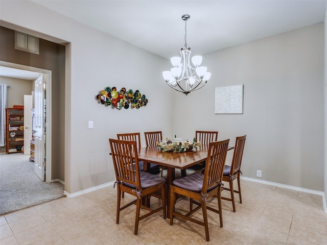 dining space with a notable chandelier and light tile patterned flooring