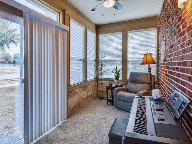 sunroom / solarium featuring ceiling fan and plenty of natural light