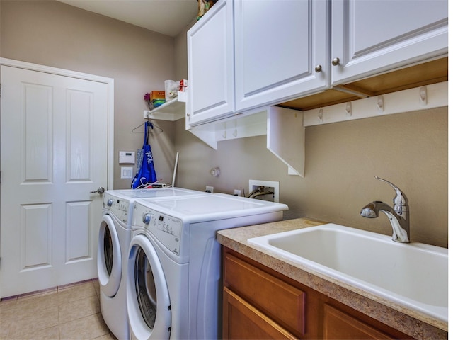 clothes washing area featuring cabinets, separate washer and dryer, sink, and light tile patterned flooring