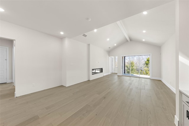 unfurnished living room featuring light wood finished floors, recessed lighting, a glass covered fireplace, high vaulted ceiling, and beamed ceiling