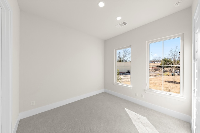 spare room with light carpet, visible vents, baseboards, and recessed lighting