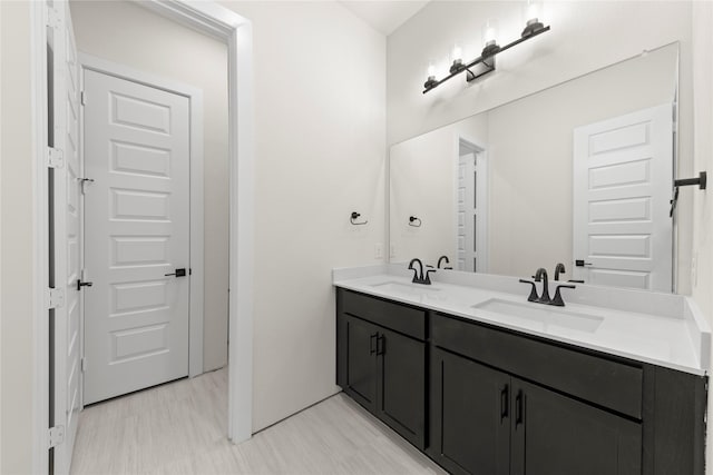 full bath featuring double vanity and a sink