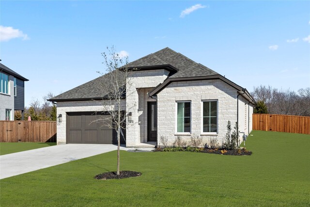 view of front of property featuring a front yard and a garage