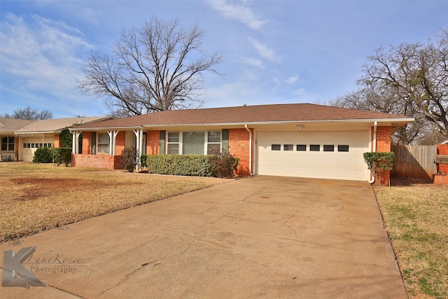 single story home with a garage and a front lawn