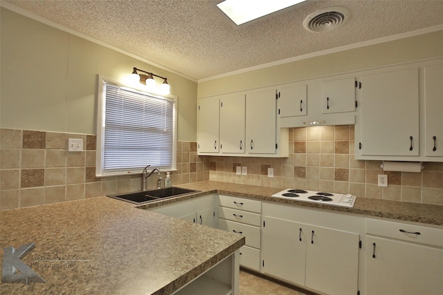 kitchen with a textured ceiling, sink, white cabinetry, and white electric cooktop