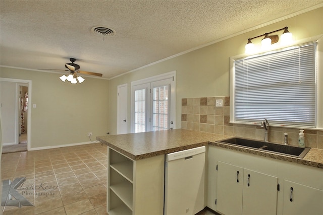 kitchen featuring kitchen peninsula, dishwasher, sink, and crown molding