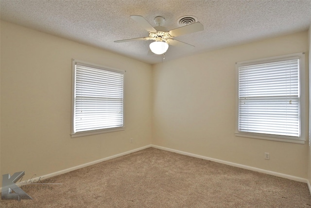 carpeted empty room featuring a textured ceiling and ceiling fan