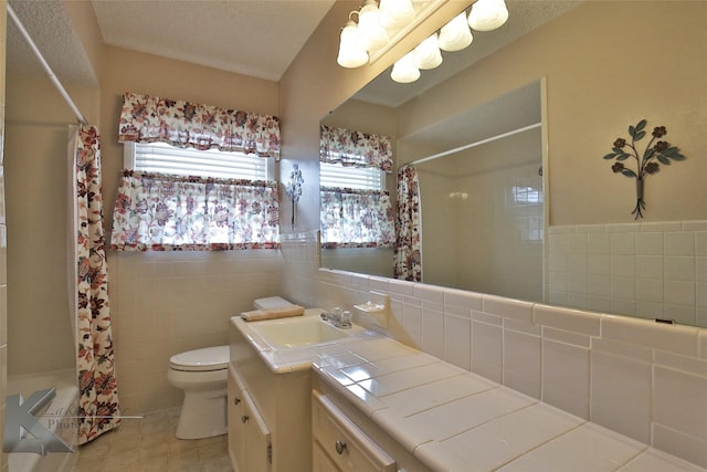 full bathroom featuring tile walls, tile patterned floors, vanity, and toilet