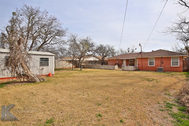 view of yard featuring cooling unit and an outbuilding