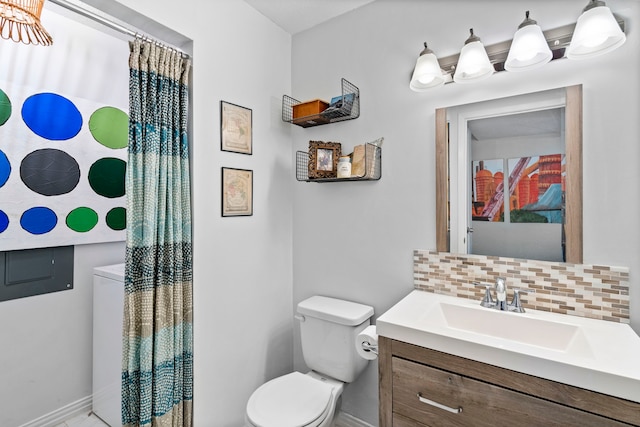 bathroom featuring toilet, tasteful backsplash, and vanity