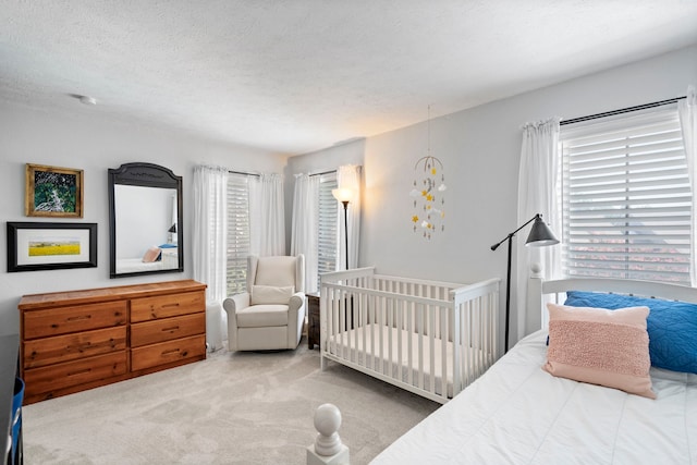 bedroom featuring a textured ceiling and carpet flooring