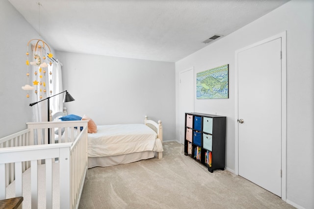 bedroom with light colored carpet