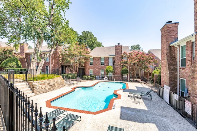 view of swimming pool featuring a patio area