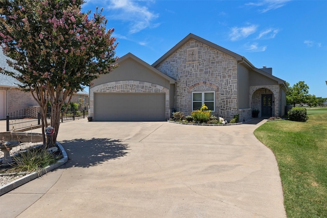 view of front of property featuring a front yard and a garage