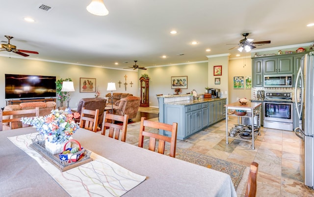 dining area with ceiling fan and ornamental molding