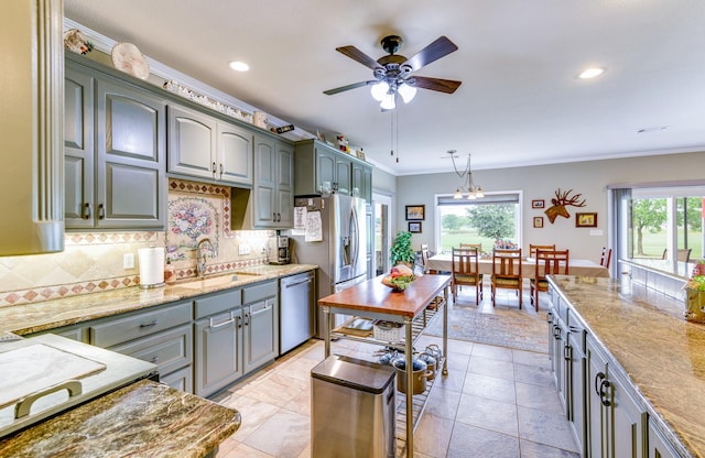 kitchen with decorative backsplash, decorative light fixtures, dishwasher, crown molding, and sink